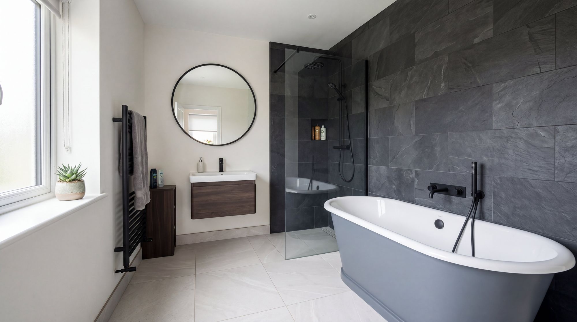 Completed bathroom with dark slate feature tile, bath and glass screen, fitted by SL Carpentry