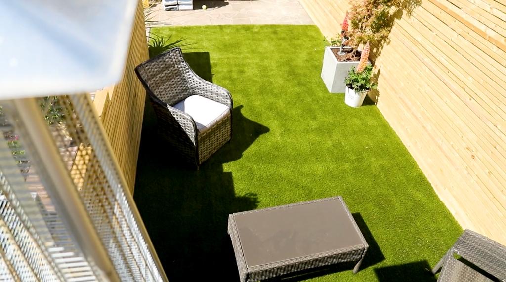 Aerial view of finished deck, artificial lawn and cedar slatted fence