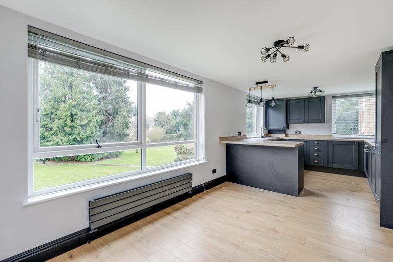 Light oak engineered flooring laid through an open-plan living space