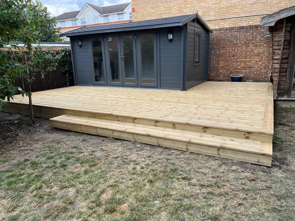 Completed softwood deck wrapping a new garden room in a South Croydon back garden